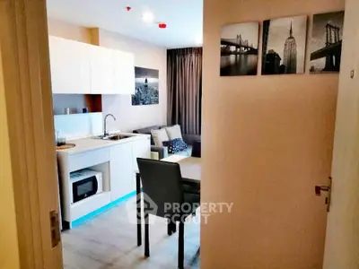 Modern open-layout kitchen and living area with stylish decor and natural light.