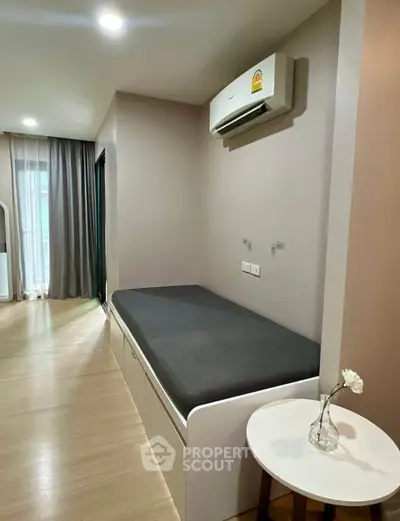 Modern bedroom with built-in bed and air conditioning, featuring sleek design and natural light.
