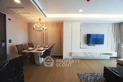 Luxurious modern living room with elegant dining area and wall-mounted TV, featuring chic lighting and stylish decor.
