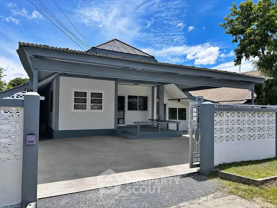 Charming single-story home with spacious driveway and modern exterior design.