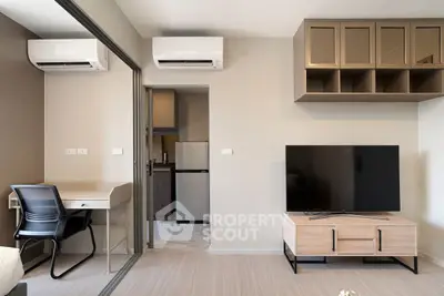 Modern apartment interior with sleek furniture and dual air conditioning units.
