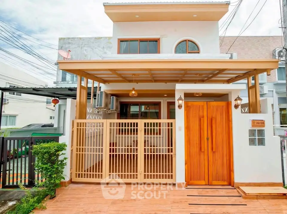 Charming modern house exterior with wooden accents and gated entrance, perfect for family living.