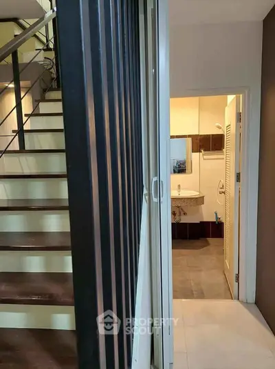 Modern duplex interior with staircase and bathroom view