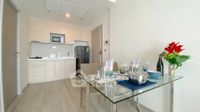 Modern kitchen and dining area with sleek design and natural light