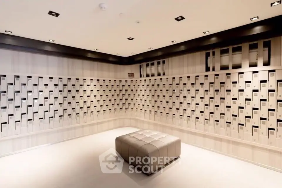 Modern lobby with stylish mailbox wall and elegant seating in upscale building.