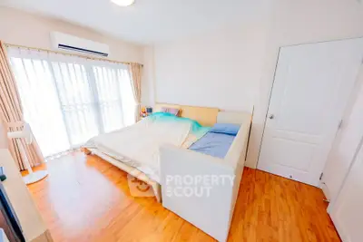 Bright and cozy bedroom with wooden flooring and natural light