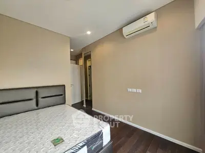 Spacious bedroom with modern air conditioning and elegant hardwood flooring