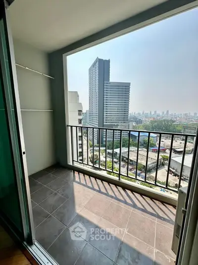 Spacious balcony with stunning city view in modern high-rise apartment