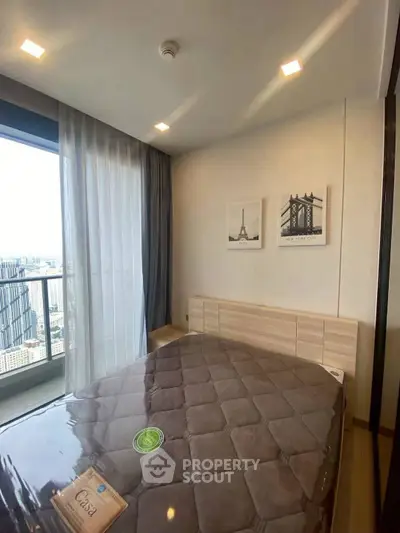 Modern bedroom with city view and stylish decor in high-rise apartment