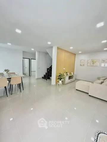Spacious modern living room with elegant dining area and stylish decor