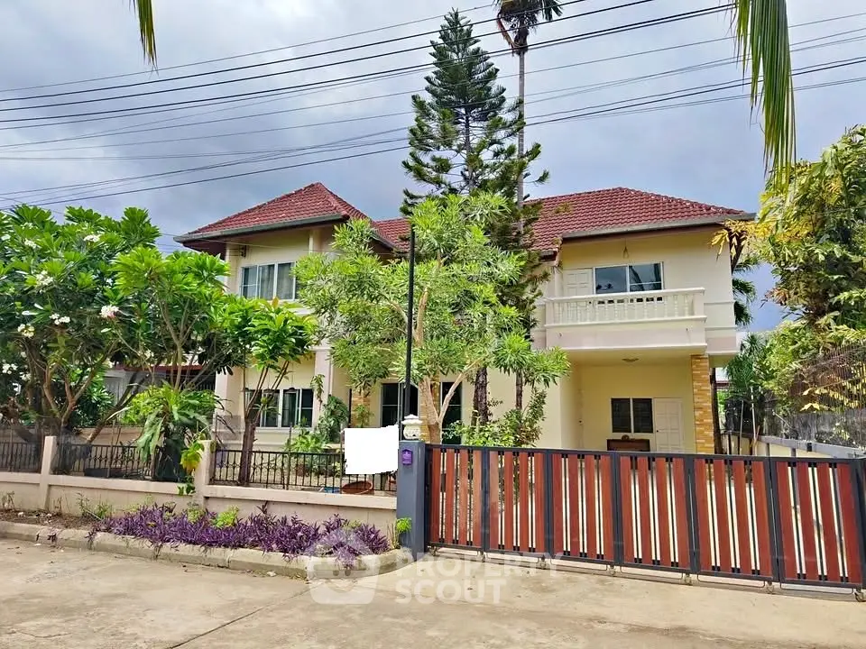 Charming two-story house with lush garden and spacious driveway in serene neighborhood.