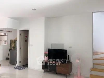 Modern living room with TV and minimalist decor