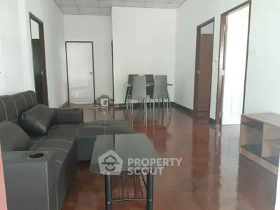 Spacious living room with modern furniture and dining area, perfect for family gatherings.