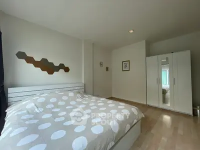 Spacious bedroom with modern decor and ample natural light