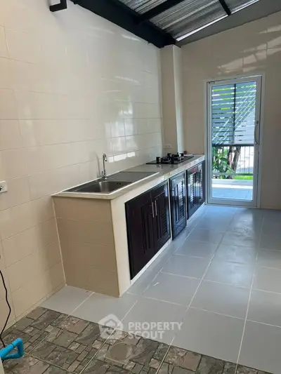 Modern kitchen with sleek cabinetry and gas stove, featuring a bright and airy design.