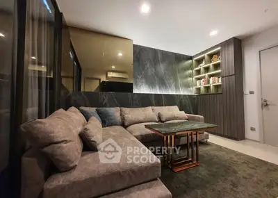 Modern living room with stylish gray sofa and built-in shelving