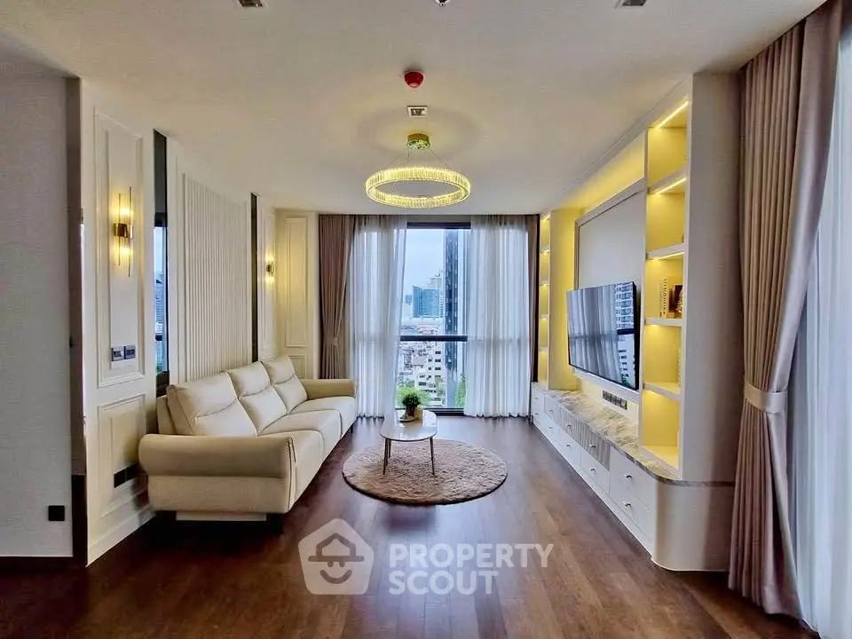 Luxurious living room with elegant decor and city view, featuring a plush sofa and modern entertainment center.