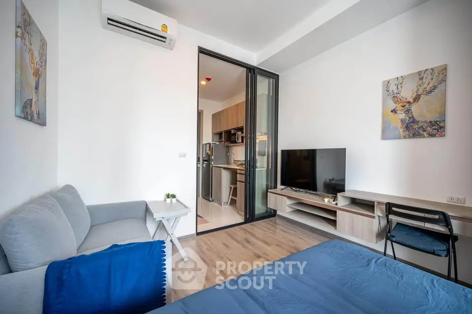 Modern living room with cozy sofa, TV, and stylish decor in a contemporary apartment.