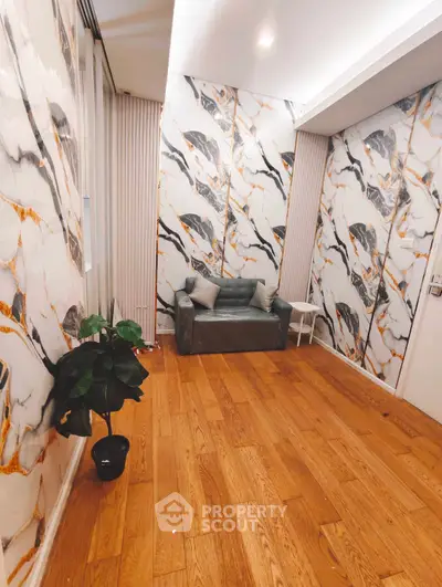 Stylish interior with marble-patterned walls and cozy seating area, perfect for modern living.