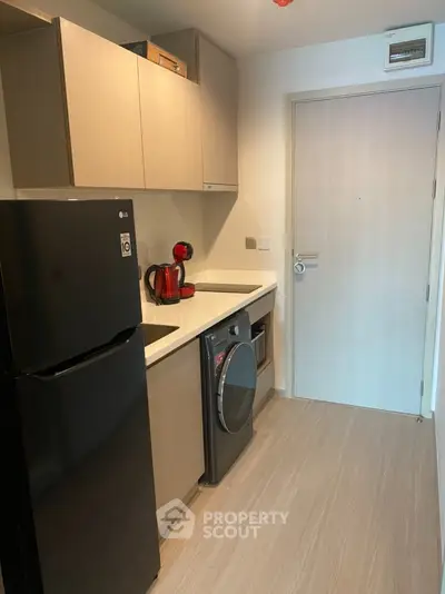 Modern compact kitchen with sleek appliances and minimalist design
