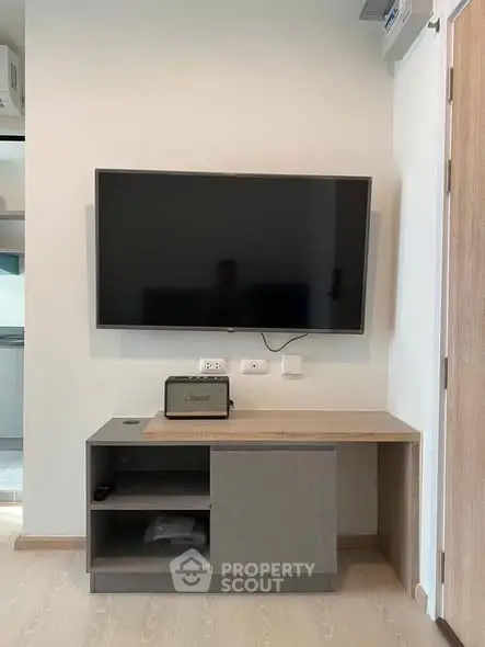 Modern living room with wall-mounted TV and stylish cabinet