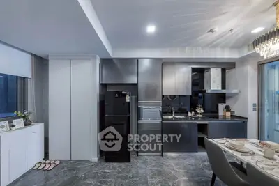 Modern kitchen with sleek black cabinetry and elegant dining setup