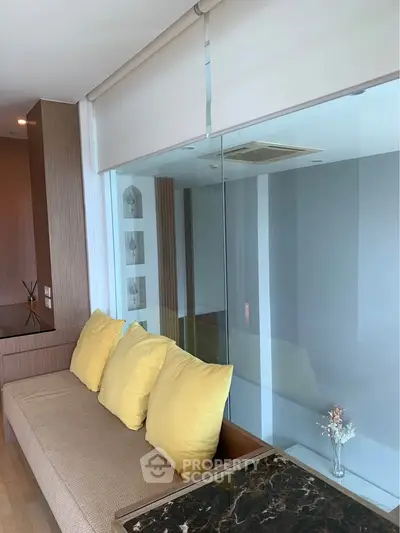 Modern living room with cozy seating and large window view