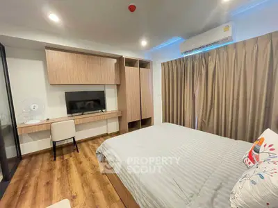 Modern bedroom with stylish decor and wooden flooring