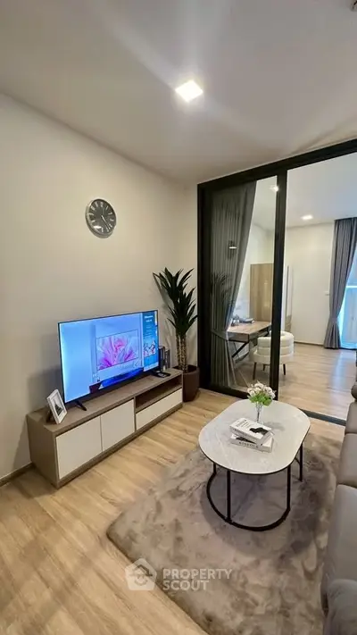Modern living room with stylish decor and open layout, featuring a cozy seating area and elegant furnishings.