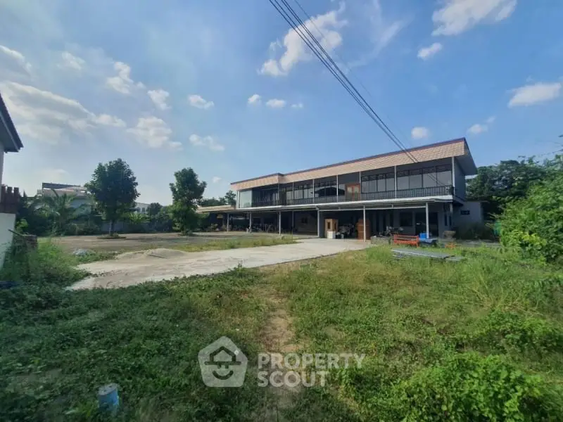 Expansive property with lush greenery and spacious outdoor area, perfect for development opportunities.