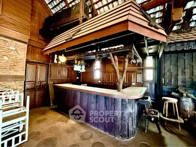 Rustic wooden bar area with unique tree trunk feature and vintage decor