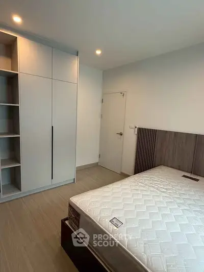 Modern bedroom with sleek wardrobe and comfortable bed in a stylish apartment.