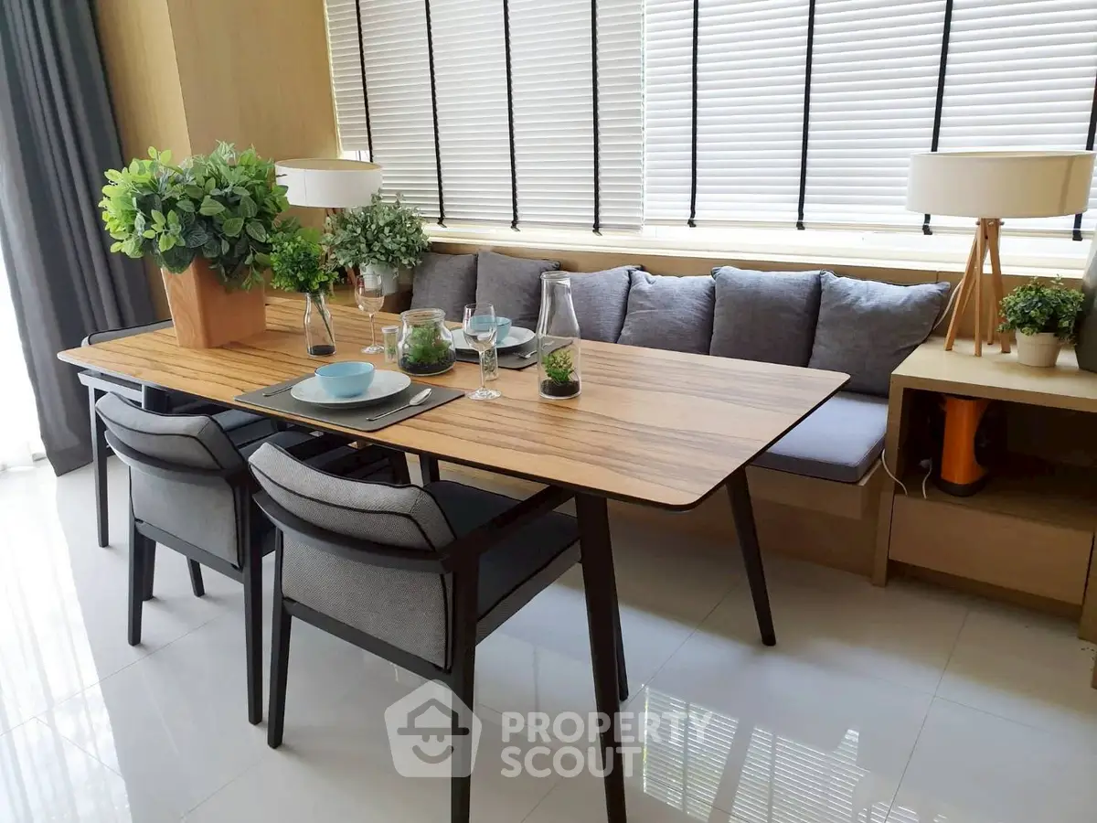 Modern dining area with sleek table, cozy seating, and stylish decor