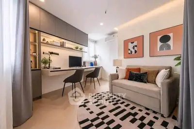 Modern living room with stylish decor and workspace, featuring a cozy sofa and elegant wall art.