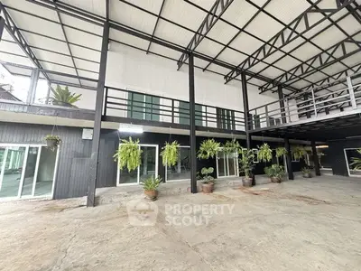 Spacious industrial-style building with modern design and lush greenery