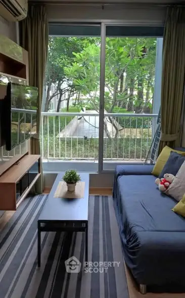Cozy living room with garden view, modern furniture, and natural light.
