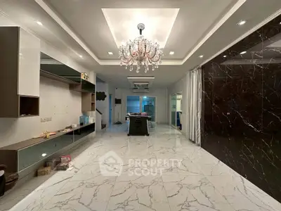 Luxurious living room with marble flooring and elegant chandelier, perfect for sophisticated gatherings.