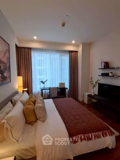 Cozy bedroom with elegant decor and natural light, featuring a comfortable bed and stylish furnishings.