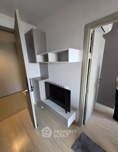 Modern living room with sleek TV unit and wooden flooring