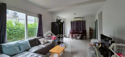 Spacious living room with modern decor and large window view