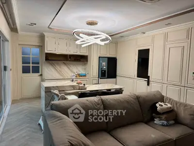 Modern kitchen with open layout and stylish lighting in cozy living area.