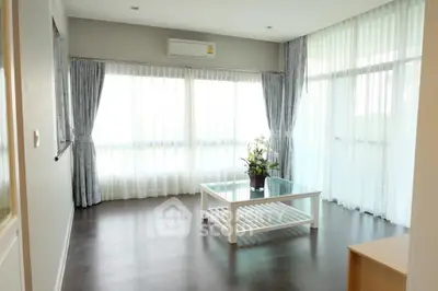 Spacious living room with large windows and modern decor