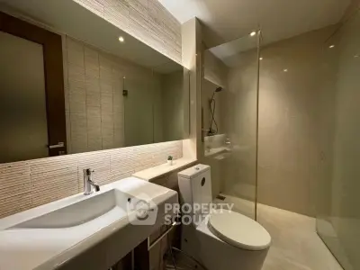 Modern bathroom with sleek fixtures and spacious shower area.