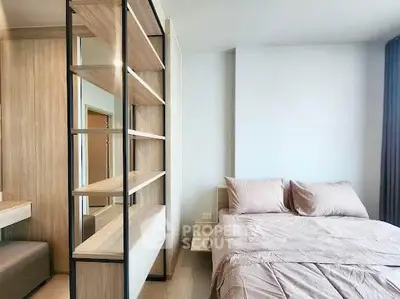 Modern bedroom with stylish shelving and cozy bedding in a bright apartment.
