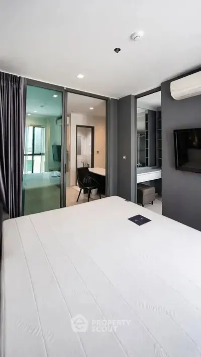 Modern bedroom with ensuite bathroom and sleek design in a luxury apartment.