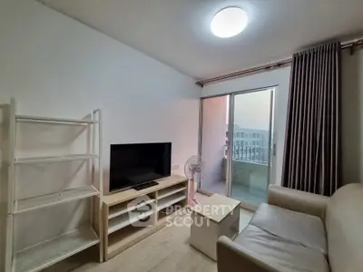 Cozy living room with modern furniture and balcony access in a stylish apartment.