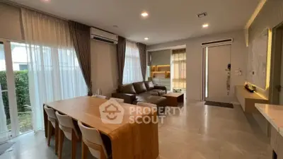 Modern living room with elegant furniture and natural light, perfect for family gatherings.