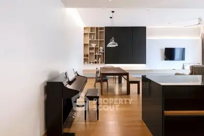 Modern open-plan living room with piano and stylish dining area