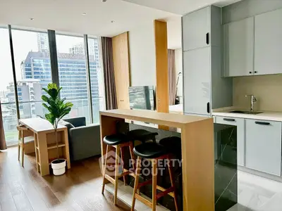 Modern open-layout kitchen and living area with city view