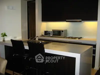 Modern kitchen with sleek countertops and built-in appliances in a stylish apartment.